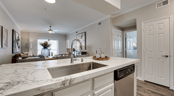 an open kitchen with a large counter top and a sink  at Highland Luxury Living, Lewisville, Texas